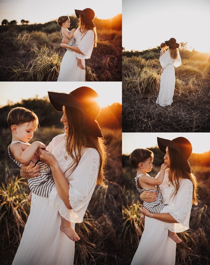 Mother in white lace dress holding child in striped shirt during golden hour field session, mommy and me family photography with natural backlighting at sunset
