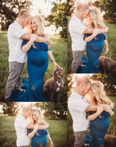 Couple embracing in open field maternity session with dog present, pregnant woman in blue gown, golden hour lighting and candid connection