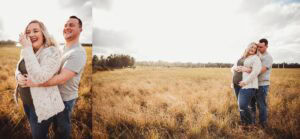 Pregnant woman cradling belly in cream lace maternity outfit during golden hour sunset
